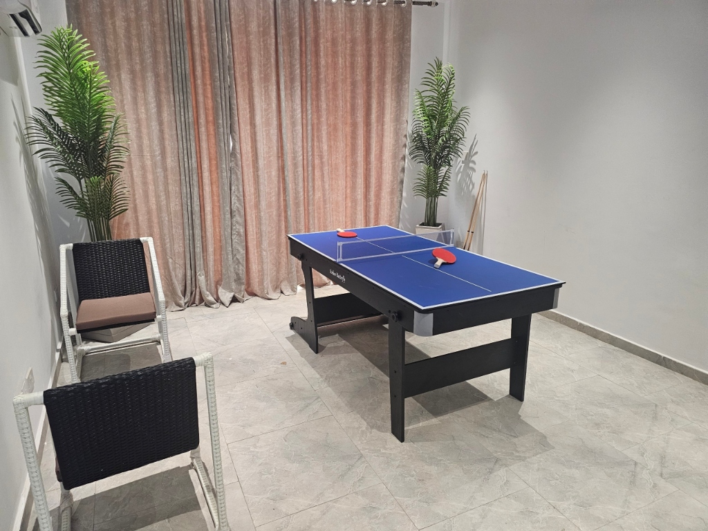 Royal Bliss executive game room featuring table tennis, snookers, chess set, and lounge chairs